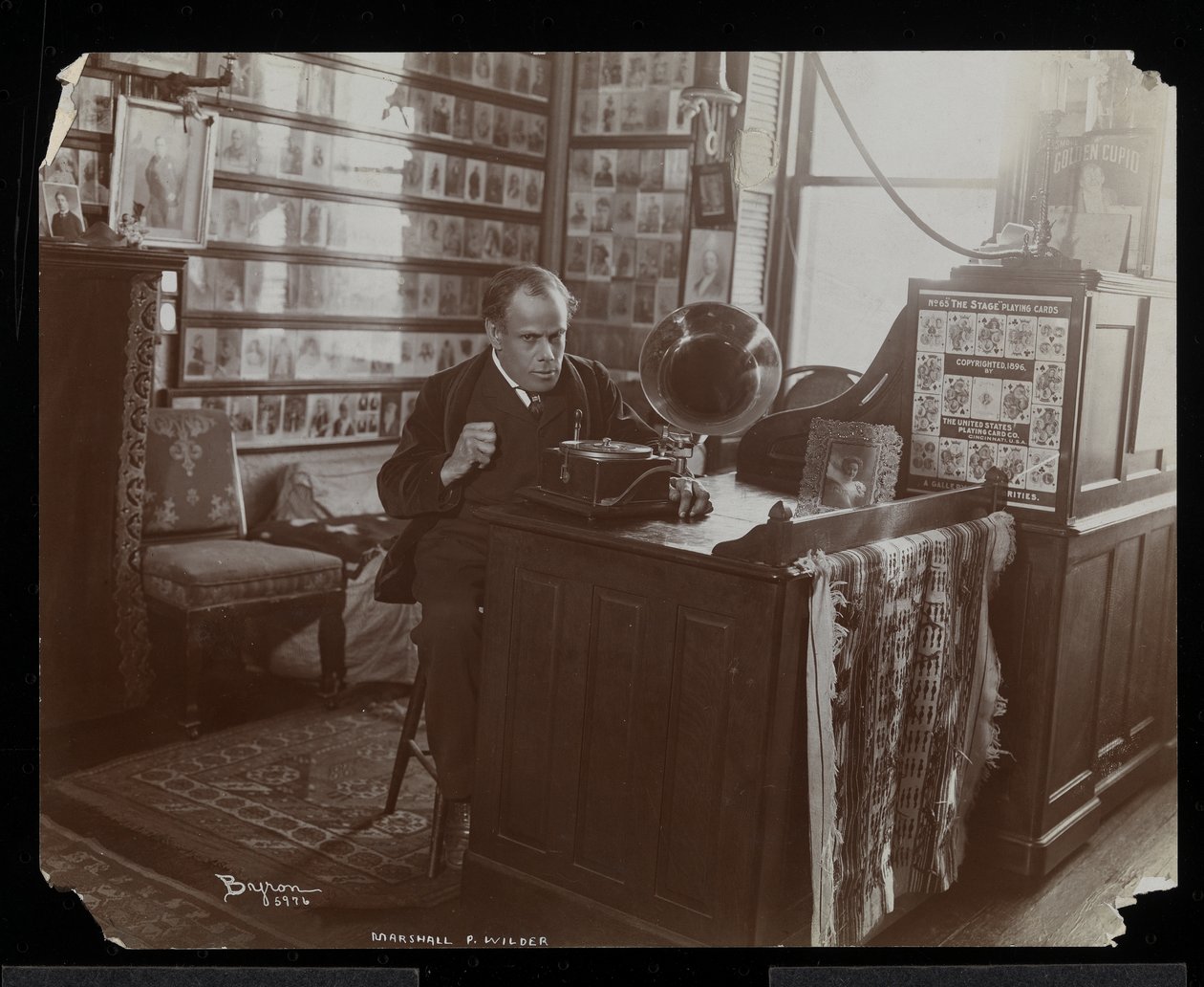 Marshall P. Wilder ascolta un disco su una victrola nel suo ufficio da Byron Company
