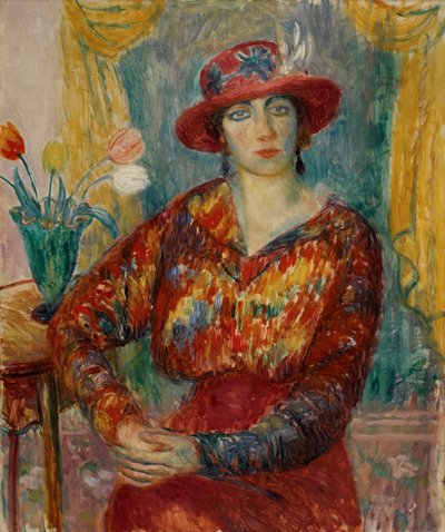 Donna in camicetta rossa con tulipani da William James Glackens